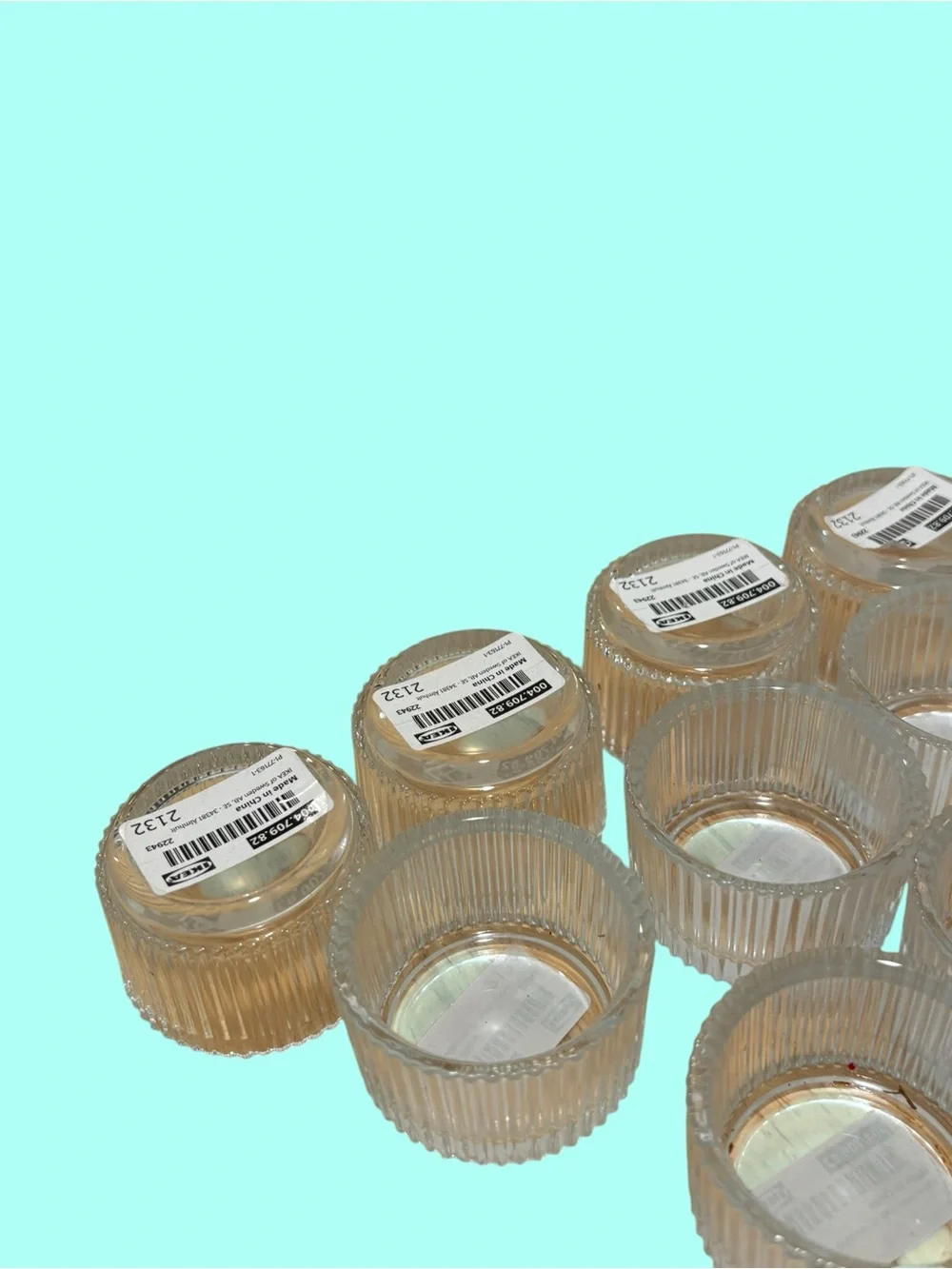 21 IKEA FINSMAK clear glass tealight holders.